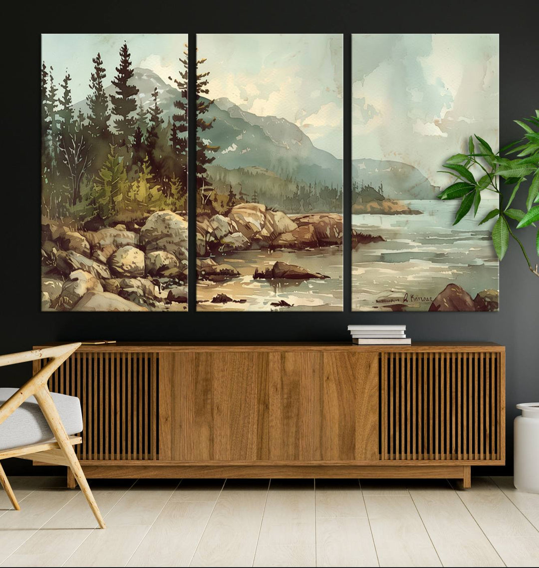 The living room features a breathtaking three-panel Abstract Acadia National Park Wall Art Canvas Print, which beautifully captures the rocky Maine coastline with trees and mountains.