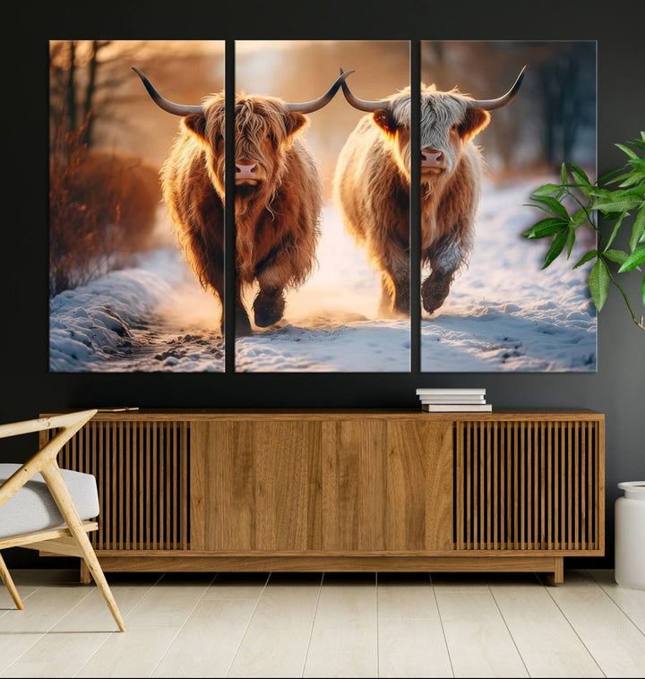 The living room showcases a triptych from the Scottish Highland Cow Horn Farm Wall Art Canvas Print collection, depicting two Highland cows running in the snow. Complementing this are handmade wall art pieces with a gallery-quality finish that add an elegant touch.