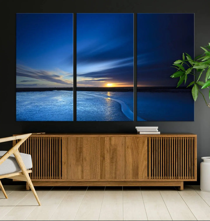 The living room features a triptych of the Wall Art Canvas Print Navy Sunset Lake Landscape Artwork, adding to its tranquil vibe.