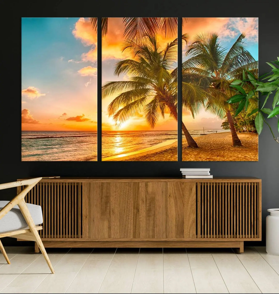 The Tropical Sunset Wall Art Print features a vibrant beach scene with palm trees and an ocean view highlighted by a golden sunset.