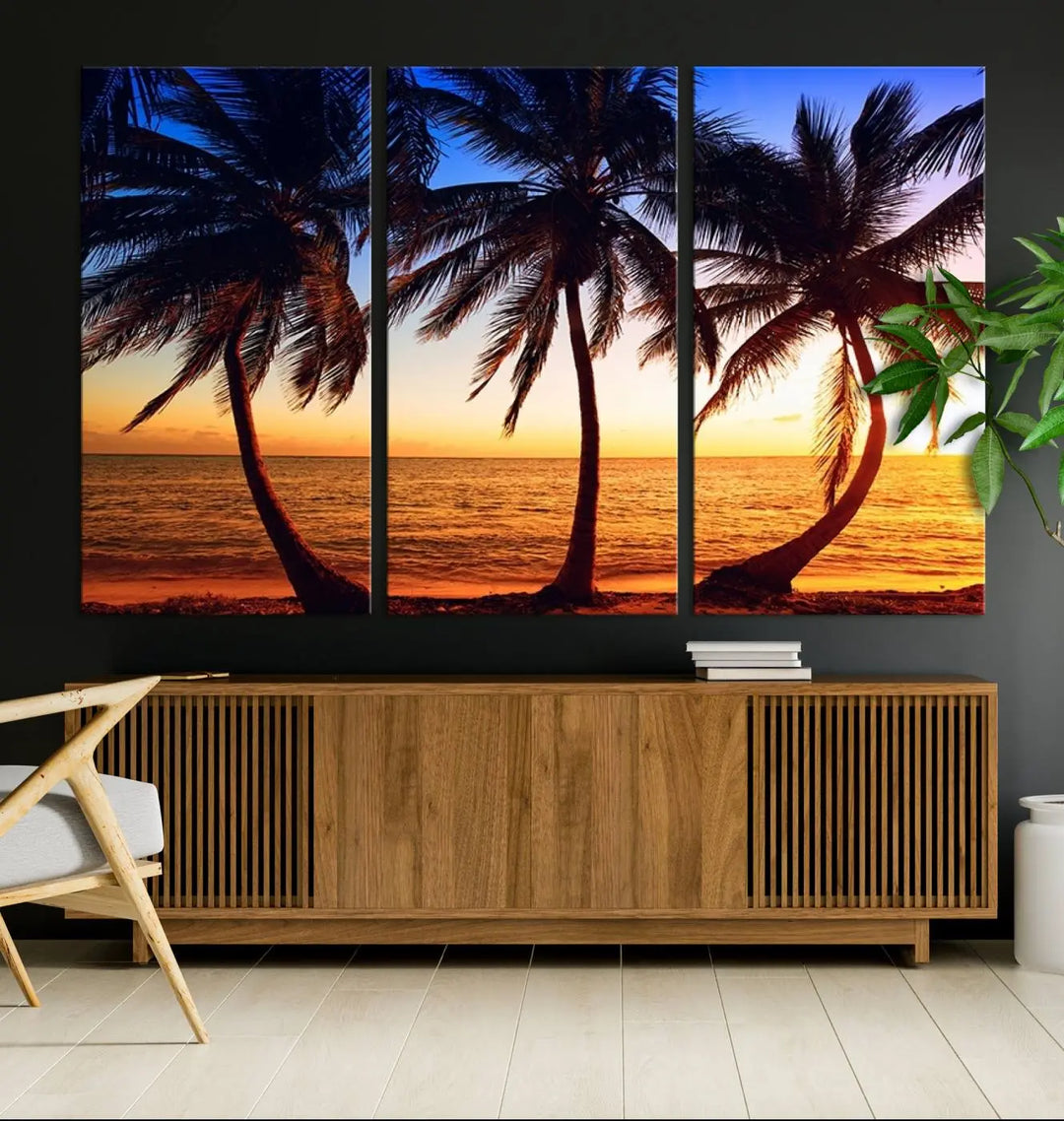 The living room features a wall adorned with the "Wall Art Canvas Curve Palms at Sunset on Beach," showcasing gallery-wrapped, museum-quality canvases in a stunning triptych.