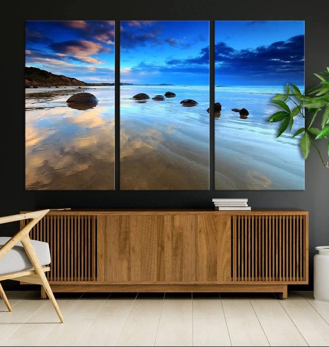 An elegant triptych artwork titled "Wonderful Beach Landscape with Mountain," beautifully displayed on museum-quality canvas, enhances the stylish living room.