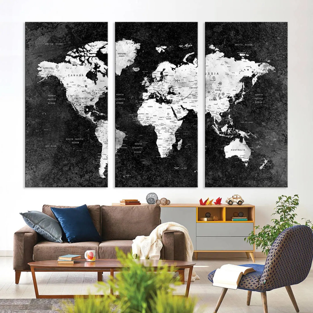 The Modern Grayscale World Map 3-Panel Canvas Art, ready to hang and framed, stylishly adorns the space above the sofa in a contemporary living room. It complements the minimalist décor with its black and white tones.