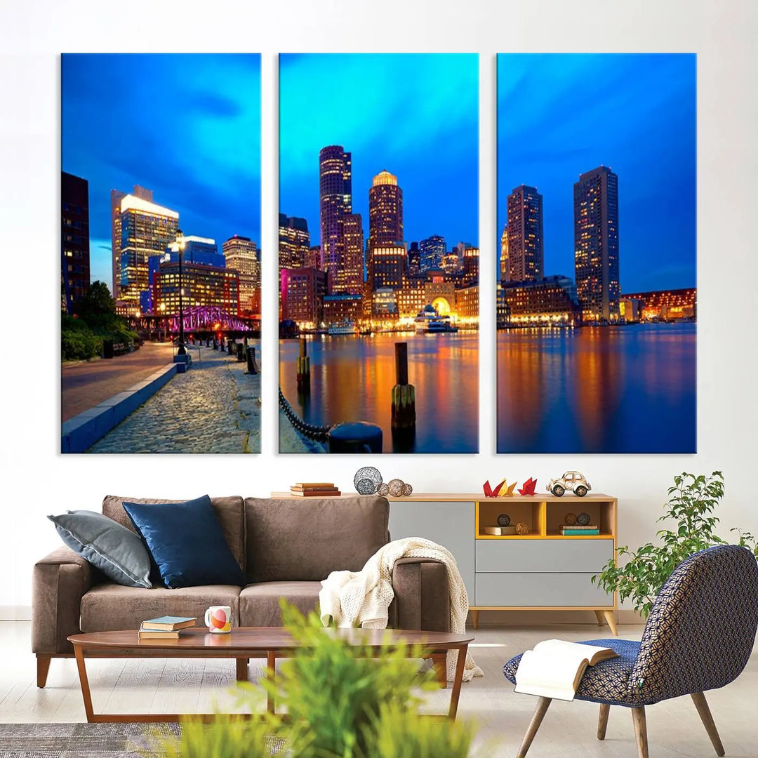 A triptych of the "Boston City Lights Night Blue Skyline Cityscape View Wall Art Canvas Print" adorns the wall. This museum-quality canvas artwork is ready to hang and includes a UV-protective coating for lasting brilliance.