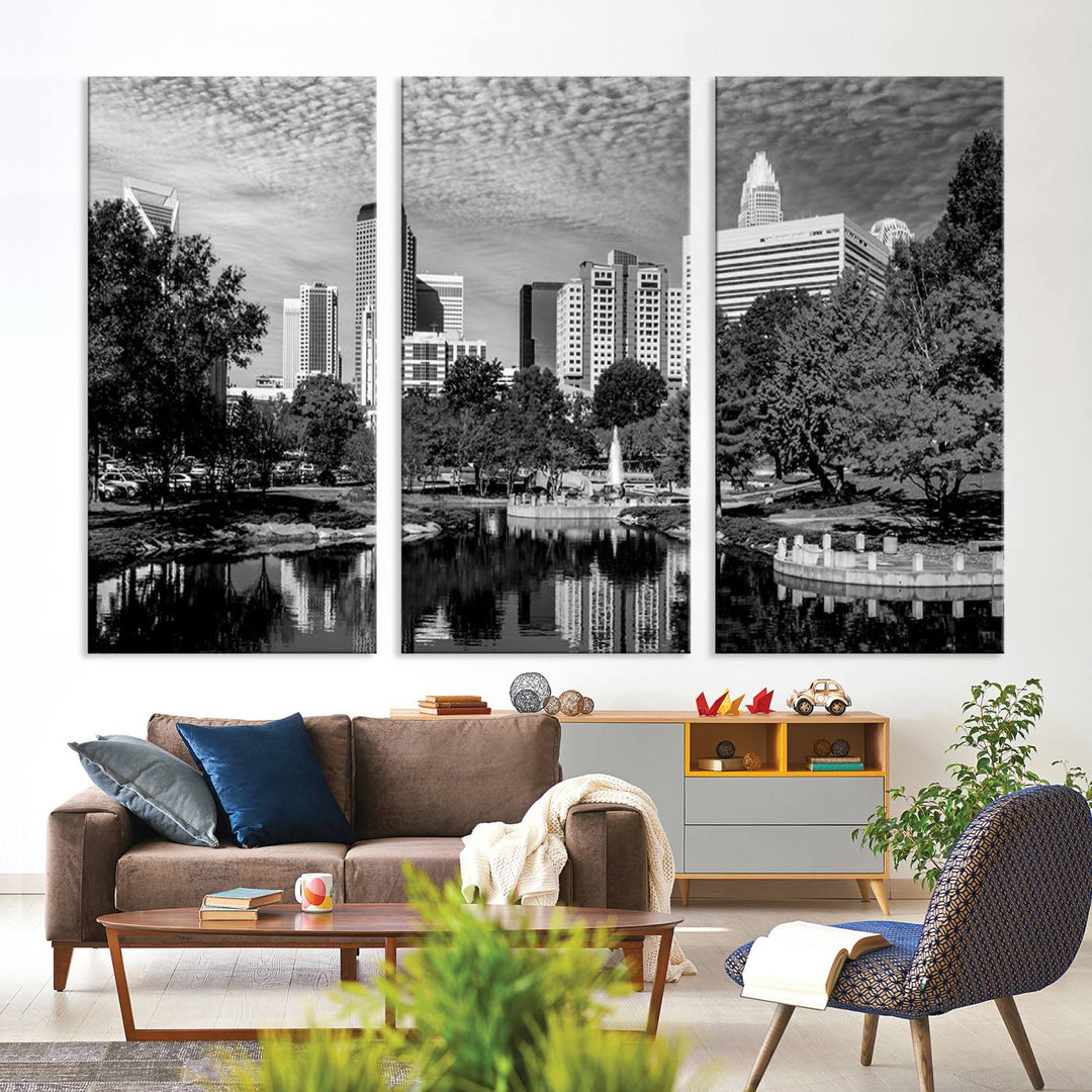 The living room features a captivating triptych titled "Charlotte City Cloudy Skyline Black and White Wall Art Cityscape Canvas Print," crafted on museum-quality canvas with UV-protective coating. Modern decor accentuates the dynamic scene.