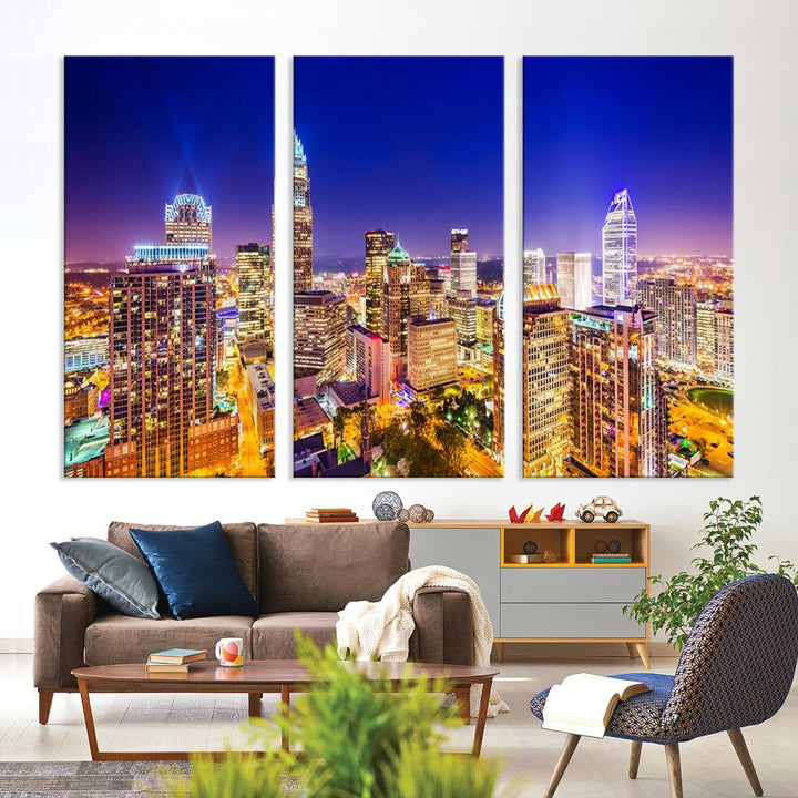 A modern living room features the Charlotte City Lights Night Blue Skyline Cityscape View wall art canvas print.