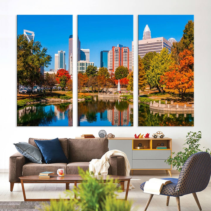 The Charlotte City Park at Fall Skyline Cityscape View wall art canvas print features a city panorama with a park and lake accented by autumn trees. It is mounted on museum-quality canvas with UV-protective coating and decorates the space.