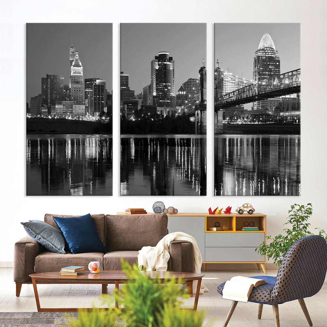 The wall showcases a ready-to-hang triptych of the Cincinnati City Lights Skyline in black and white, printed on museum-quality canvas.