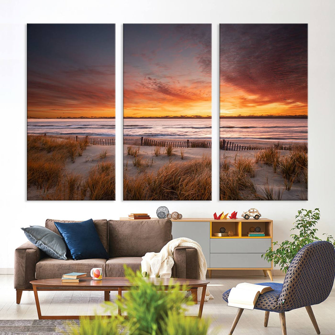 Sunset on The Beach Wall Art Canvas Print features a triptych of a beach at sunset with vivid orange skies, presented on museum-quality canvas. Each section is gallery wrapped, offering lasting beauty with its UV-protective coating.