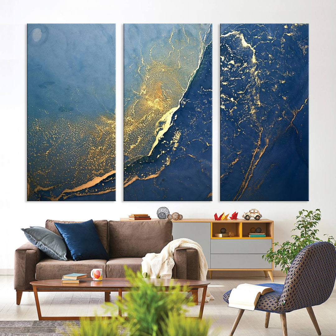 The Navy Blue Yellow Twinkle Wall Art Canvas Print, featuring an abstract design in gold and blue, enhances a modern living room as it adorns a white wall with its gallery-wrapped, museum-quality canvases for an exquisite touch.