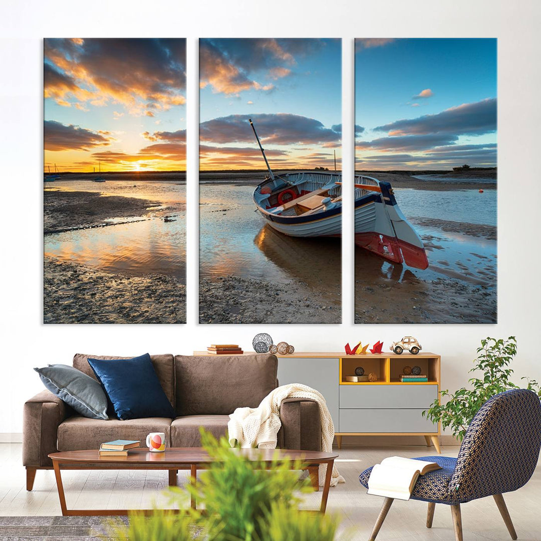 The "Small Boat At The Beach Sunset Wall Art Canvas Print," a three-panel masterpiece crafted on museum-quality canvas, hangs elegantly.