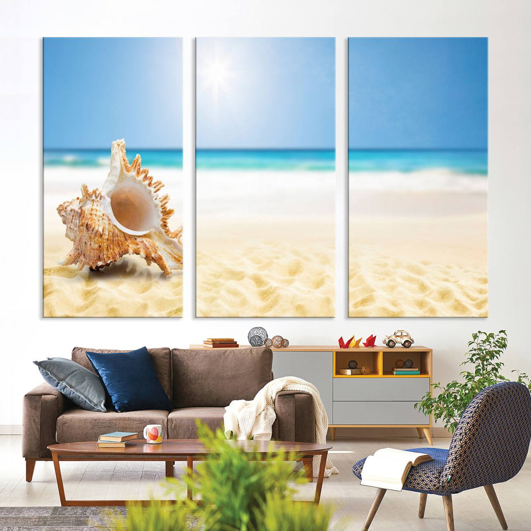 The Sea Shell on The Beach Sun Sand Wall Art Canvas Print is a triptych that beautifully captures a beach scene with a large seashell on the sand.