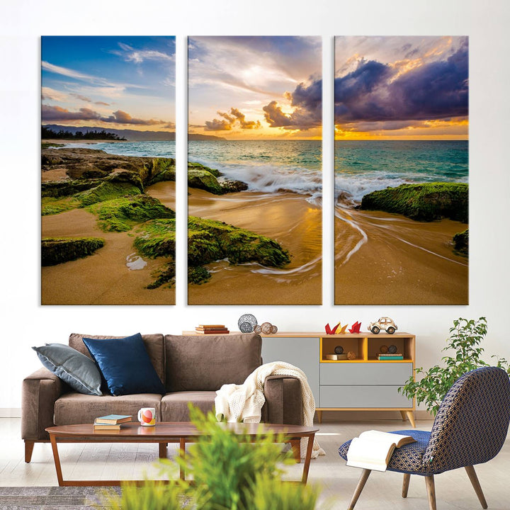 The Sunset Beach Wall Art Canvas Print is a gallery-wrapped triptych showcasing a beach scene with mossy rocks and a vibrant sunset. Made from museum-quality canvas and featuring a UV-protective coating, it elegantly provides both beauty and durability.