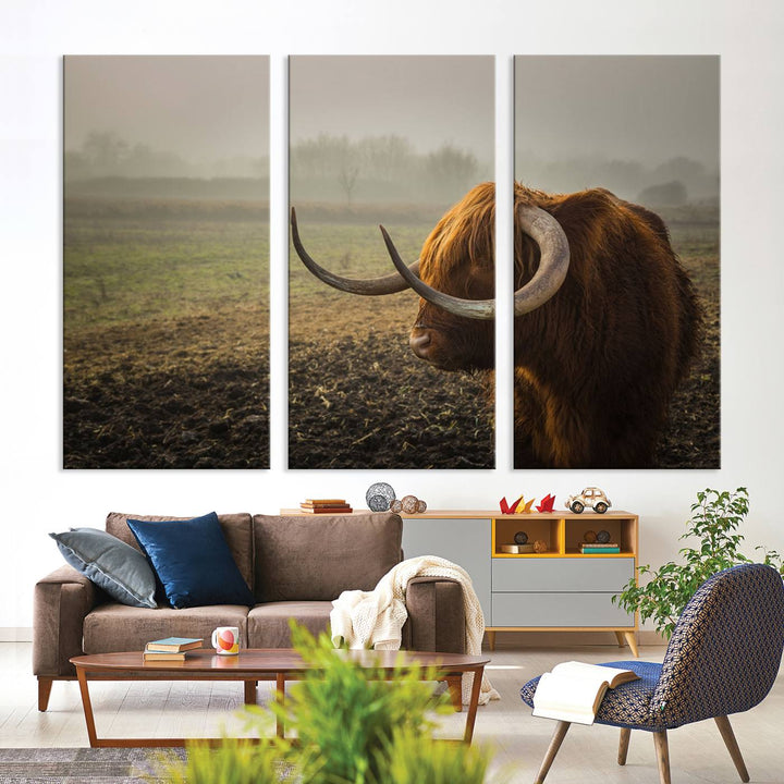 The "Big Cow Horn Wall Art Canvas Print" is a hand-assembled framed canvas depicting a Highland cow in a misty field. It is crafted with a UV-protective coating to ensure lasting vibrancy.