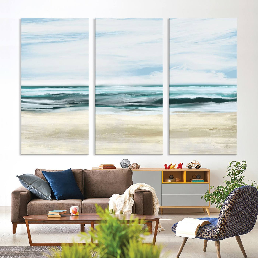 The room features the Ocean Abstract Wall Art Canvas Print, a triptych beach painting on museum-quality canvas with a gallery-wrapped finish and UV-protective coating.