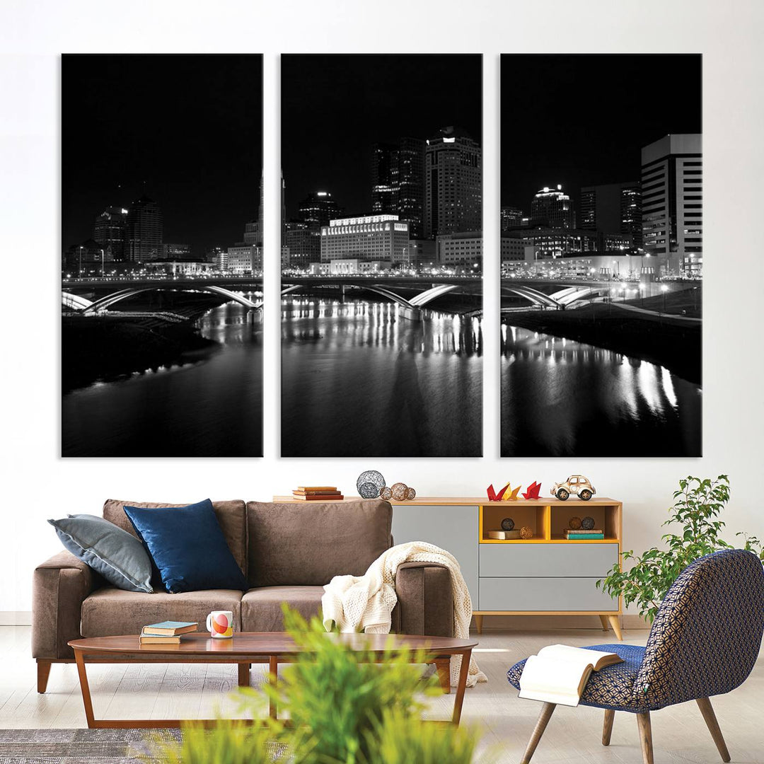 The living room features the "Columbus City Lights Skyline Black and White Wall Art Cityscape Canvas Print" above a coffee table. This artwork is presented as a triptych on museum-quality canvases with UV-protective coating.