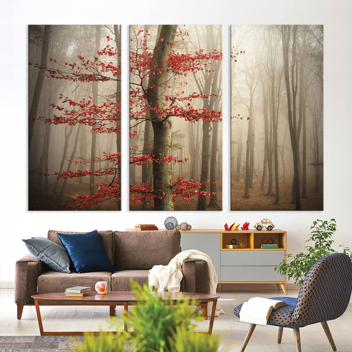 Foggy forest wall art with autumn trees and red leaves, 3-panel canvas print displayed in living room.