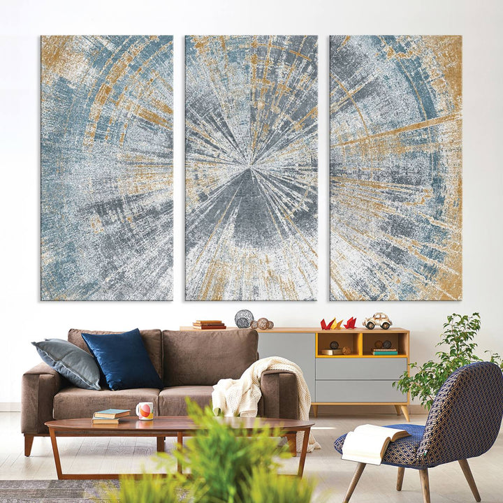 The Radiant Abstract Wood Rings Canvas Art, a modern triptych wall decor, enhances the contemporary style of the living room with its blue, white, and gold hues.