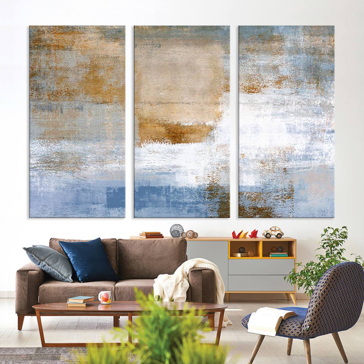 The Blue Multi Panel Abstract Wall Art Canvas Print, featuring an elegant blend of blue, beige, and brown tones, hangs gracefully on the wall, adding a contemporary touch to the space.