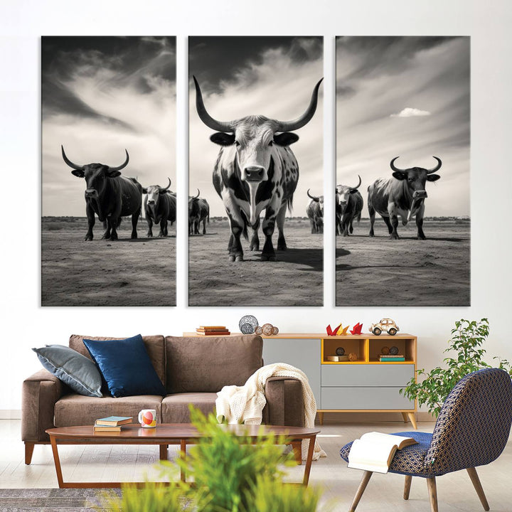 The Black and White Longhorn Cattle Wall Art, featuring a three-panel display of cowboy Western longhorns walking toward the viewer, enhances your space with its striking presence, adding a touch of Western decor.