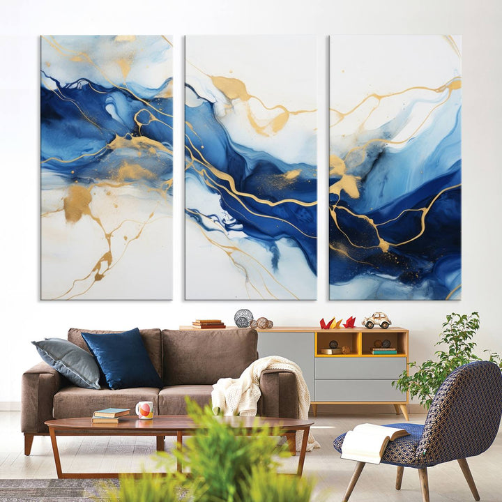 The Blue Abstract Wall Art is displayed as a triptych on museum-quality canvas, showcasing a blue and gold abstract design. The artwork includes a UV-protective coating to maintain its vibrancy and comes with the benefit of free shipping.