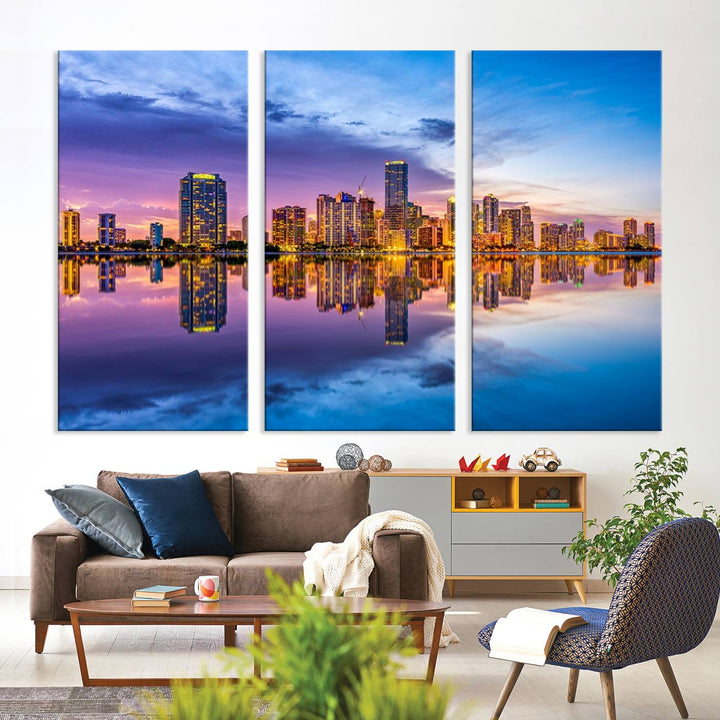 The Miami City Wall Art Canvas Print, featuring a three-panel depiction of a city skyline at sunset reflected in water, beautifully enhances the wall. Made with museum-quality canvas and a UV-protective coating, it comes ready to hang.