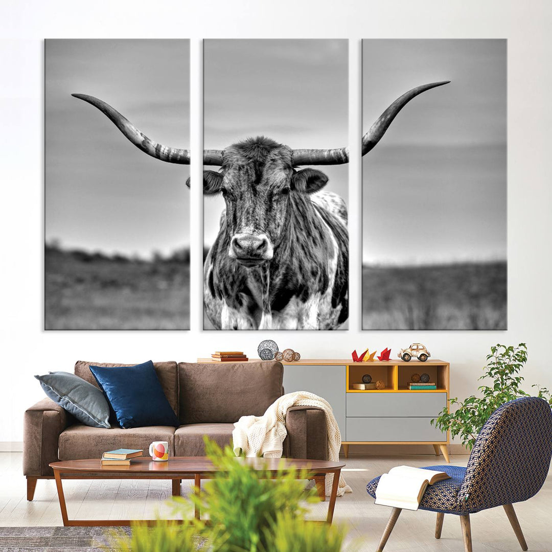 The Texas Longhorn Cow Wall Art, featuring a black and white image of a longhorn bull on canvas, brings charm to the room with its sophisticated appeal.