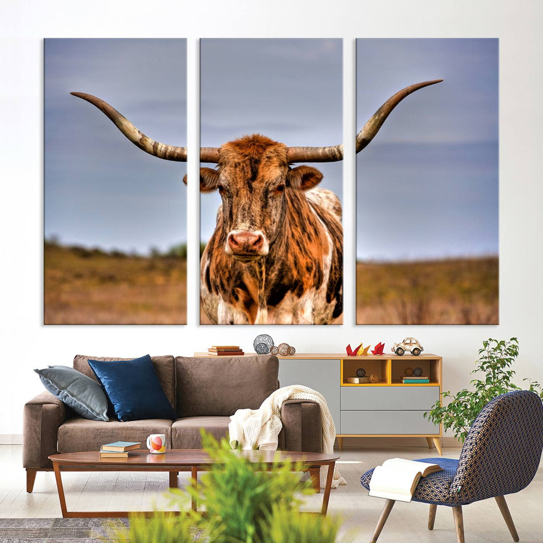 The Texas Longhorn Wall Art Print, a triptych canvas artwork depicting a longhorn bull in a field, features a gallery-quality finish.