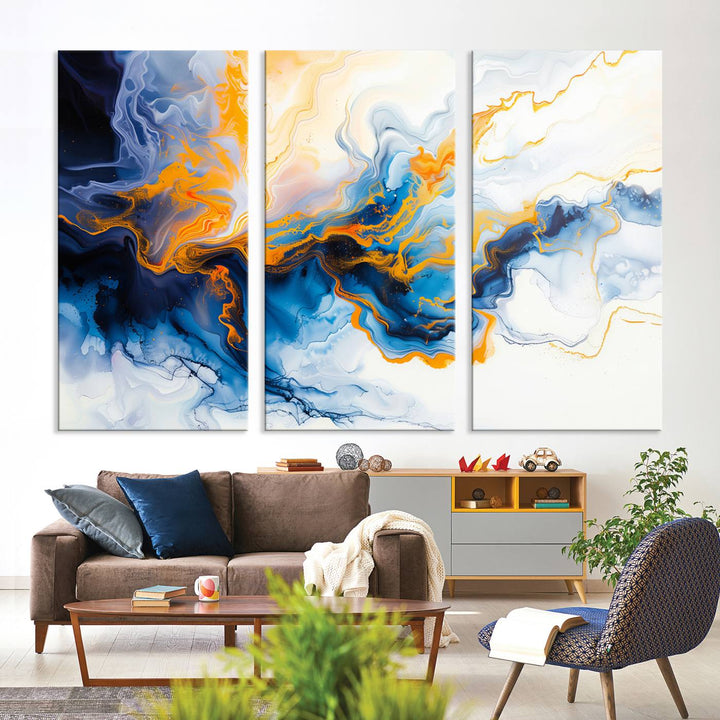 A stunning Fluid Alcohol Ink Wall Art with Gold Wall Art Canvas Print, featuring vibrant blue, orange, and white swirls, adorns the wall. This gallery-quality finish adds an exquisite touch to any living space.