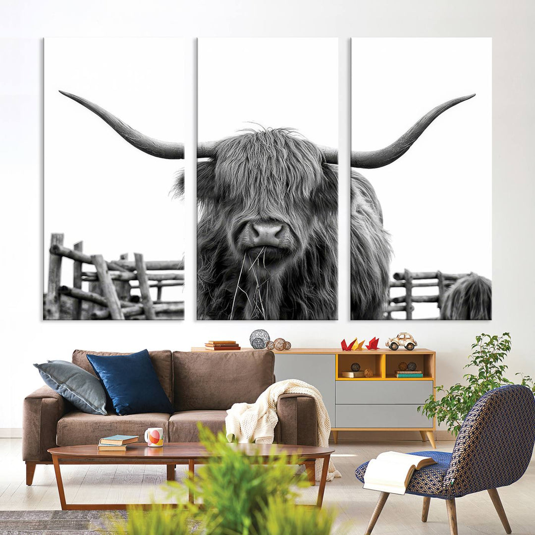 The Longhorn Canvas Print, featuring a black-and-white triptych of a Bighorn cow with shaggy fur and impressive long horns, is elegantly showcased. This wall art piece boasts a gallery-quality finish on premium canvas, bringing sophistication to any room.