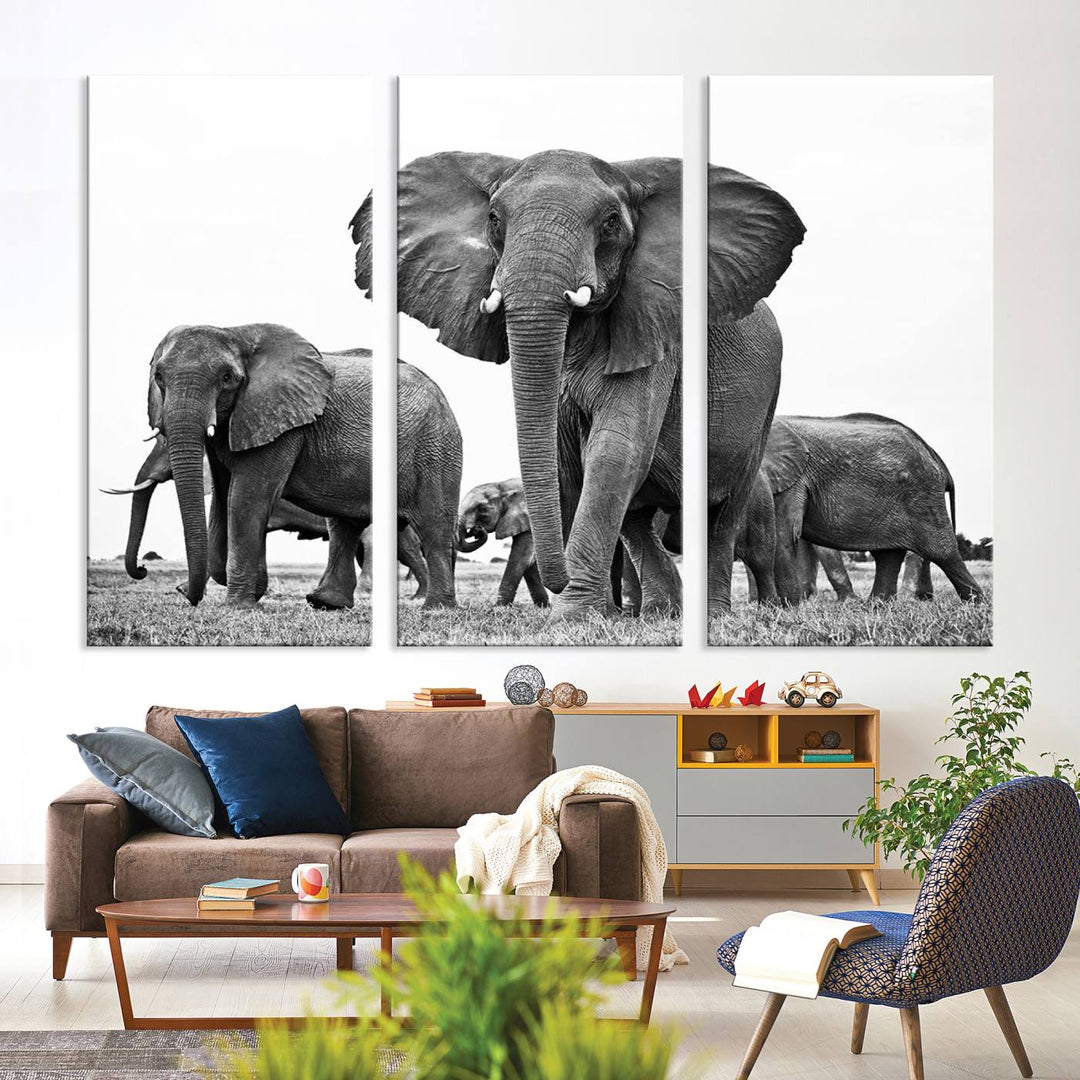 The Black White Elephant Family Wall Art Canvas Print features a triptych of elephants walking in the wild, crafted as gallery-quality wall art on premium canvas.