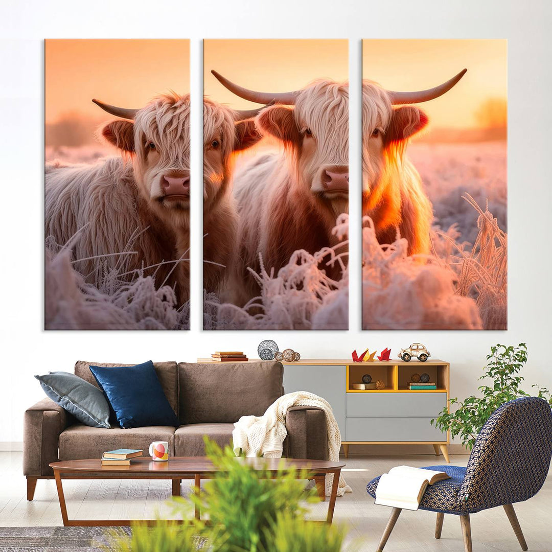 The "Highland Cows at Sunrise Wall Art Canvas Set" beautifully captures a serene and rustic farmhouse aesthetic, portraying two Highland cows in a frosty landscape at sunrise.