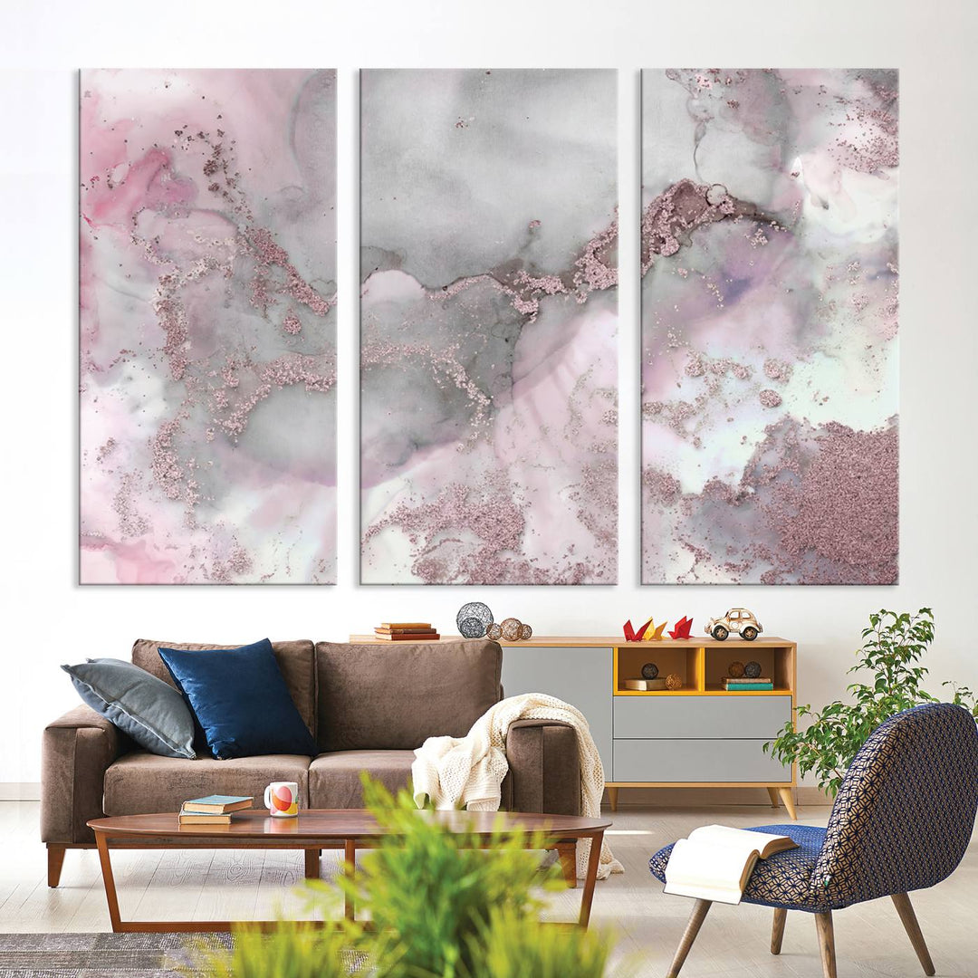 The Rose Marble Abstract Wall Art Canvas Print is a stunning triptych that showcases pink and gray tones, elegantly presented on a dark wall.