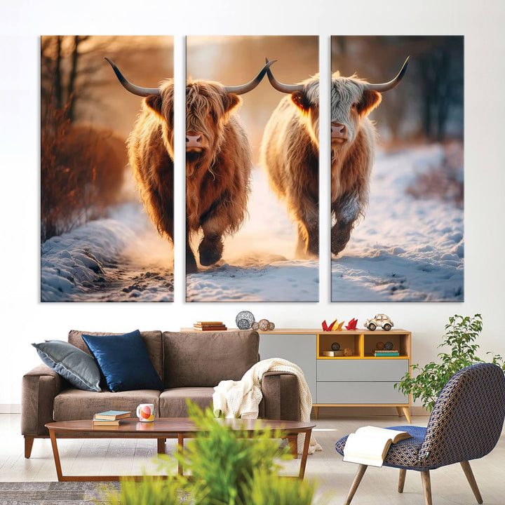 The living room showcases a triptych from the Scottish Highland Cow Horn Farm Wall Art Canvas Print collection, depicting two Highland cows running in the snow. Complementing this are handmade wall art pieces with a gallery-quality finish that add an elegant touch.