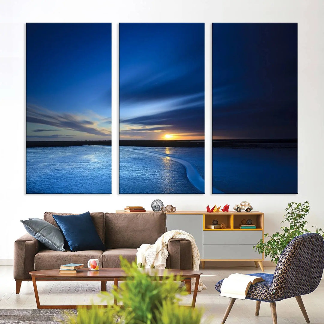 The living room features a triptych of the Wall Art Canvas Print Navy Sunset Lake Landscape Artwork, adding to its tranquil vibe.