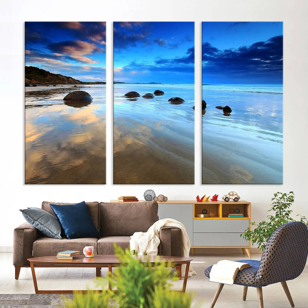 An elegant triptych artwork titled "Wonderful Beach Landscape with Mountain," beautifully displayed on museum-quality canvas, enhances the stylish living room.