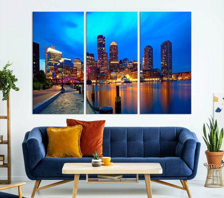 A triptych of the "Boston City Lights Night Blue Skyline Cityscape View Wall Art Canvas Print" adorns the wall. This museum-quality canvas artwork is ready to hang and includes a UV-protective coating for lasting brilliance.