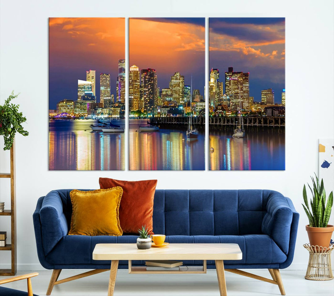 A contemporary dining area features a large triptych wall art of the Boston City Night skyline in blue and orange hues, printed on museum-quality canvases to ensure lasting beauty.