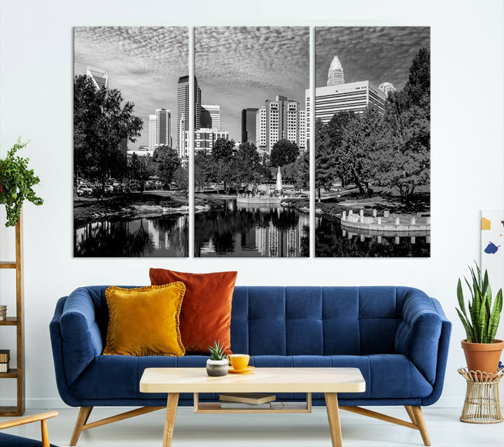 The living room features a captivating triptych titled "Charlotte City Cloudy Skyline Black and White Wall Art Cityscape Canvas Print," crafted on museum-quality canvas with UV-protective coating. Modern decor accentuates the dynamic scene.