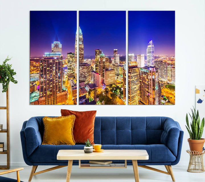 A modern living room features the Charlotte City Lights Night Blue Skyline Cityscape View wall art canvas print.