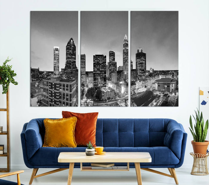 The "Charlotte City Cloudy Skyline Black and White Wall Art Cityscape Canvas Print" hangs on a dark wall, showcasing its UV-protective properties for enduring beauty.