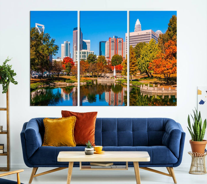 The Charlotte City Park at Fall Skyline Cityscape View wall art canvas print features a city panorama with a park and lake accented by autumn trees. It is mounted on museum-quality canvas with UV-protective coating and decorates the space.