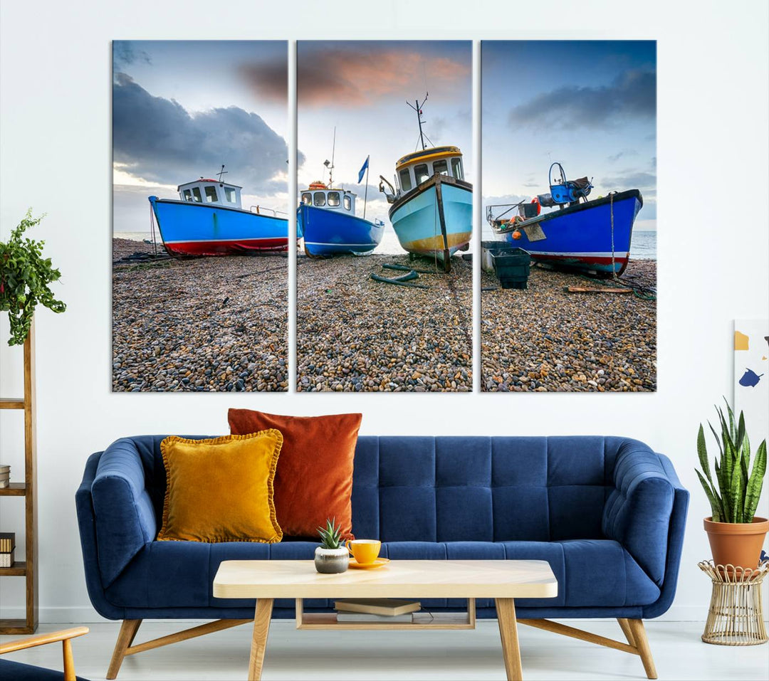 The "Big Boats On The Beach Wall Art Canvas Print" is a stunning piece featuring three museum-quality panels depicting fishing boats on a pebbled shore. Ready to hang and featuring UV-protective coating, it serves as an elegant addition to your home décor.