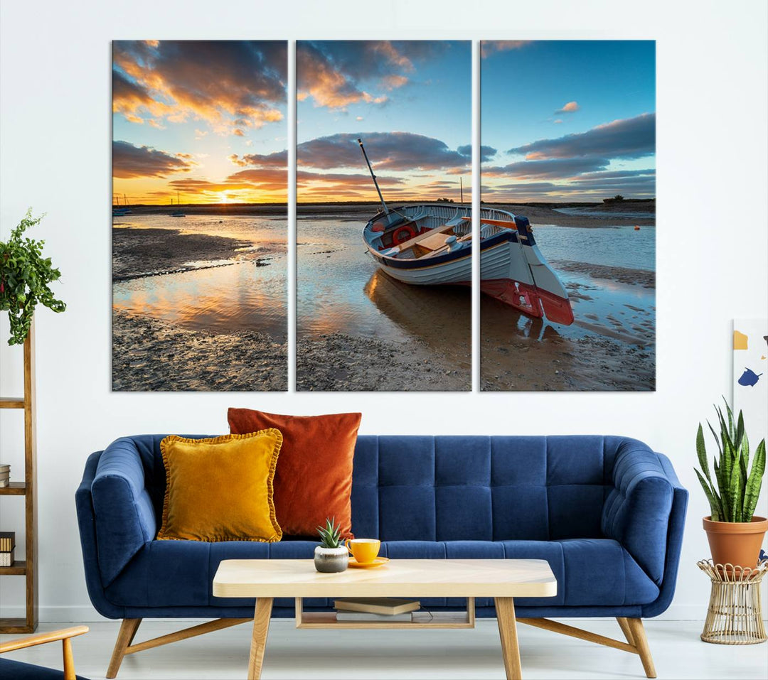 The "Small Boat At The Beach Sunset Wall Art Canvas Print," a three-panel masterpiece crafted on museum-quality canvas, hangs elegantly.