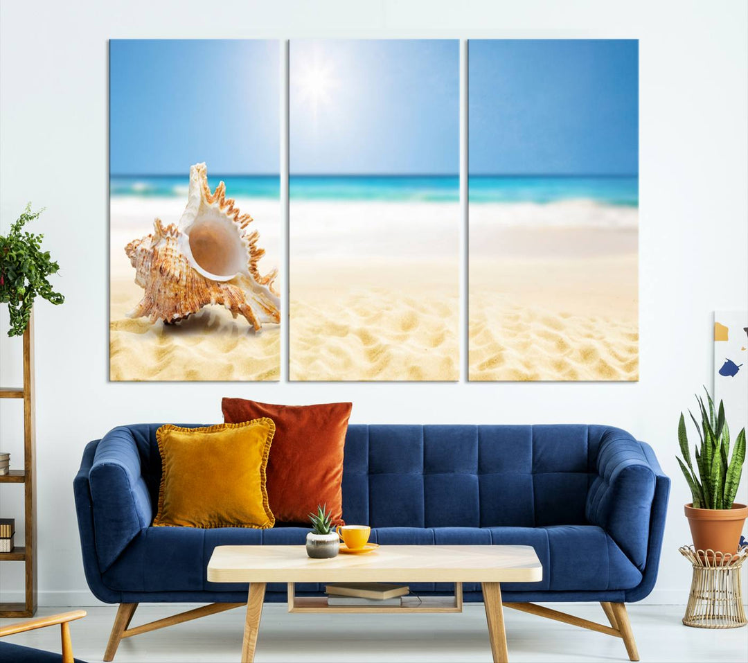 The Sea Shell on The Beach Sun Sand Wall Art Canvas Print is a triptych that beautifully captures a beach scene with a large seashell on the sand.