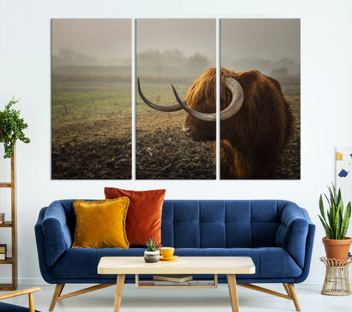 The "Big Cow Horn Wall Art Canvas Print" is a hand-assembled framed canvas depicting a Highland cow in a misty field. It is crafted with a UV-protective coating to ensure lasting vibrancy.