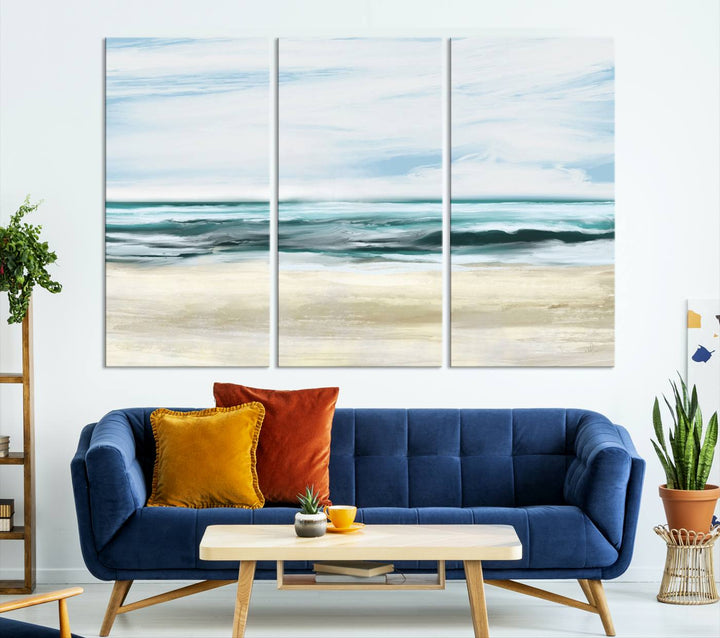 The room features the Ocean Abstract Wall Art Canvas Print, a triptych beach painting on museum-quality canvas with a gallery-wrapped finish and UV-protective coating.