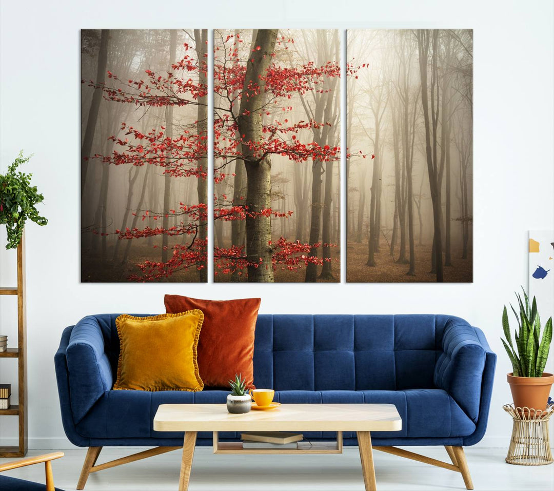 Foggy forest wall art with autumn trees and red leaves, 3-panel canvas print displayed in living room.