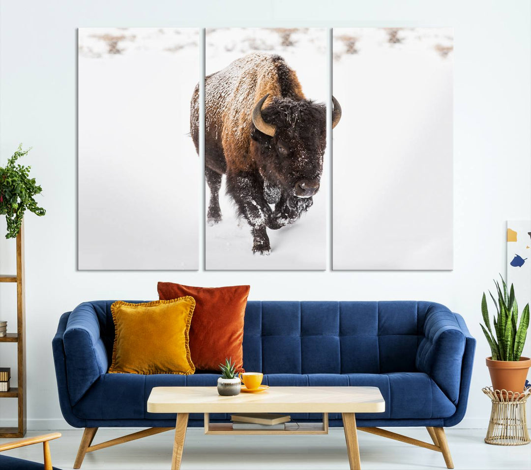 The Bison Winter Wall Art Canvas Print for Farmhouse Decor is displayed as a triptych in the living room. This artwork, printed on museum-quality canvases with a UV-protective coating to maintain its vibrant colors, is the focal point of the space.