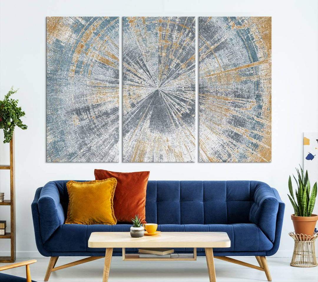 The Radiant Abstract Wood Rings Canvas Art, a modern triptych wall decor, enhances the contemporary style of the living room with its blue, white, and gold hues.